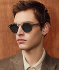 Man wearing Double Bridge Round Polarized Sunglasses For Men With UV Protection Retro Tortoise Eyewear Nickel Free Metal Brow Design Classic Dope Sunnies For Everyday Wear And All Day Comfort.