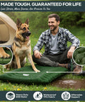 Man and dog sitting on Ultralight Camping Sleeping Pad 17.5 Oz compact inflatable mattress in green field near a tent
