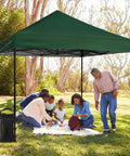 Heavy Duty Sand Bags For Canopy Legs Set Of 4 add stability to a pop-up tent in a park setting, people gathered under a green canopy.