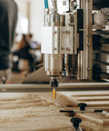 Badass Durability 24 Piece 1/4 Inch Shank Router Bits Set For Swift Precision Woodworking mounted on a CNC machine.