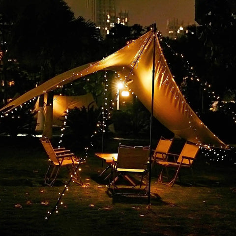 2 Pack Outdoor Solar String Lights 72 Ft With 200 LEDs, IP65 Waterproof illuminating a garden tent setup at night.