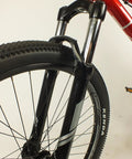 Front view of Salire SJ-50 Dirt Jumper Bike with disc brakes, 26 inch wheels, 100mm suspension fork, and beefy steel frame.