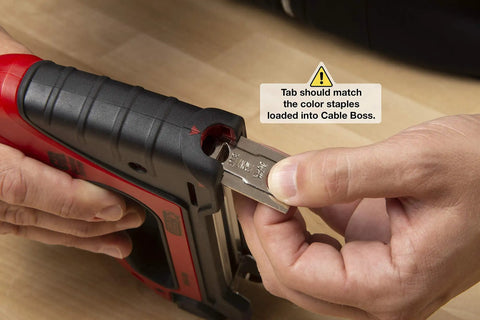 Inserting staples into Heavy Duty Cable Boss Staple Gun Pro Grade for NM Coax and Low Voltage Wiring with ergonomic handle.