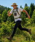 Man hiking with Waist Clip Fan Portable Personal Fan With 5000mAh Rechargeable Battery on chest through forest