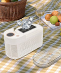 Great Slick And Totally Nifty Mini Countertop Ice Maker With 12V Car Adapter And Fast Freeze Cycle Portable Cube Maker For Rv Campers Cars Homes And Road Trips Everywhere on picnic table with ice cubes.