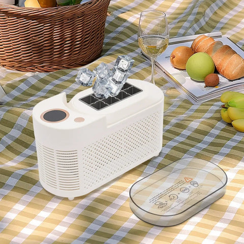 Great Slick And Totally Nifty Mini Countertop Ice Maker With 12V Car Adapter And Fast Freeze Cycle Portable Cube Maker For Rv Campers Cars Homes And Road Trips Everywhere on picnic table with ice cubes.