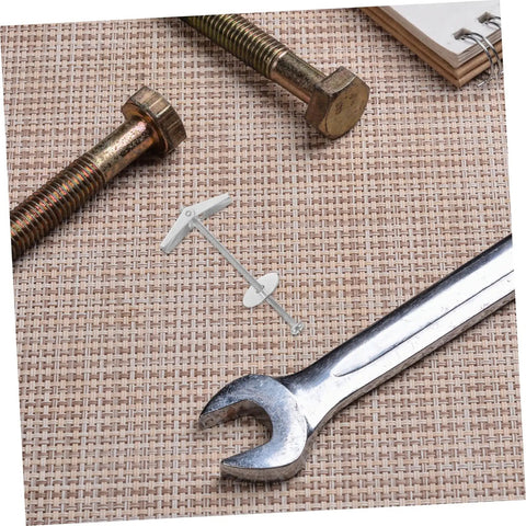15-Piece Beefed-Up Metal Toggle Bolt Kit With Wing Nuts For Drywall Anchors lying on textured surface with wrench