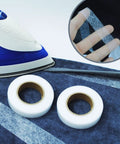 Double Sided Iron On Hemming Tape Fusible Bonding Web For Garment Repair And Crafting on blue fabric with iron and hand holding tape.
