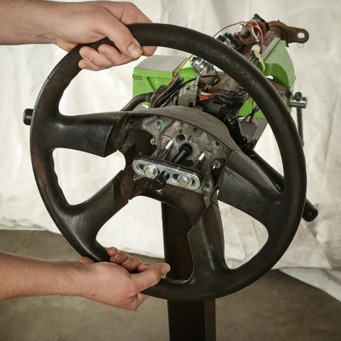 Hands using Steering Wheel Puller Kit For Quick No Hassle Removal, Durable Steel Construction, Fits Most Makes And Models