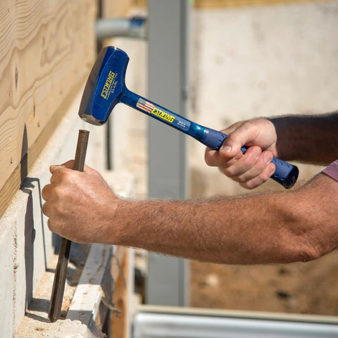 Man using Big Blue 4 Pound Drilling Hammer With Long Handle Built Like a Tank Forged Steel Construction Shock Reduction Grip Made in USA for chiseling