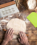 Dough Scraper and Bench Scraper Kitchen Tool Set in Stainless Steel with dough being rolled on wooden surface