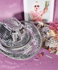 Self Adhesive Mirror Mosaic Tiles 2400 Pcs 10x10mm Disco Ball Tiles on a decorative hat and ornament display on a purple surface