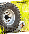 Spare Tire Hold Down Bolt Retainer Clamp For Cars And SUVs No Brainer Install shown securing a mounted spare tire on grass field