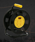 Jobsite Ready Beefy Cord Reel With 4 Grounded Outlets Black And Yellow Holds 50 Ft Of 12 Gauge 70 Ft Of 14 Gauge Or 90 Ft Of 16 Gauge Circuit Breaker Protected Extension Reel For Powering Multiple Tools, shown on a black background with yellow handle and grounded outlets
