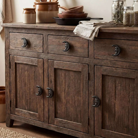 Six Piece Set Black Cast Iron Drawer Pulls And Cabinet Knobs With Crescent Moon Face Design on wooden dresser