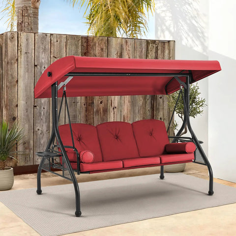 Three Seat Outdoor Porch Swing With Adjustable Canopy Convertible Patio Swing Bed With Stand Glider Swing With Upgraded Cup Holder And Thick Cushions For A Cozy Backyard Vibe In Wine Red displayed on a patio with plants.