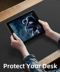 Person holding tablet on Extra Large PU Leather Desk Pad For Home Office Non Slip Waterproof Blotter Mat With Mouse Pad And Keyboard Desk Mat For Dual Screens And Two Computers 48 By 17 Inches Black