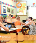 Self-adhesive dots for classroom use; classroom scene with a teacher assisting students at desks.