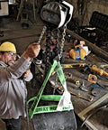Worker using a 1 Ton Hand Chain Hoist For 10 Foot Lift Model S90 100 10 Gray With Industrial Rated Alloy Steel Hooks in a workshop.