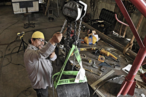 JET 1-Ton hand chain hoist with 20' lift, gray metal body, overhead mounted in workshop.