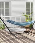 Two Person Outdoor Hammock With Adjustable Metal Stand For Patio Or Garden set up on a wooden deck, blue fabric, space-saving design.