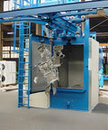 Hook Type Shot Blasting Machine For Motorcycle Parts And Components, Boss Grade Surface Prep For Frame Parts, Engine Casings, And Wheel Rims, Workshop Ready For Motorcycle Manufacturing And Assembly Shops. blue hook blasting machine with hanging motorcycle parts