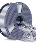 Spool of Silk PLA Plus Filament 1.75mm 1kg Silver With Chrome Like Gloss Finish beside a dragon sculpture