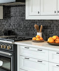 Modern kitchen with white cabinets featuring 2 Pack Black Cabinet Knobs 2 Inch Overall Length Single Hole Drawer Handles Matte Black Finish