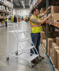 Heavy Duty Four Step Rolling Ladder With Secure Handrails Built Different For Warehouse Spaces Rock Solid Eight Hundred Eighty Pound Capacity Premium Cold Rolled Steel used for accessing high storage.