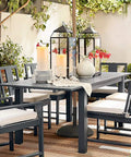 Outdoor Flameless Candles 8 by 4 Inch Waterproof Pillar Set of 2 on patio table in garden setting