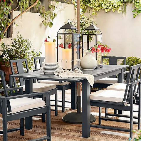 Outdoor Flameless Candles 8 by 4 Inch Waterproof Pillar Set of 2 on patio table in garden setting