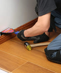 Person installing flooring wearing Flat Knee Pads For All Kneeling Jobs, Heavy Duty Knee Cushions With Anti Skid Grip And Adjustable Clips