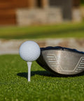 Golf club and ball on Beefy 5x5 Golf Practice Mat With Realistic Fairway Feel Nylon Surface Indoor Outdoor Turf Tee Compatible