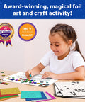 Child using Foil Fun Letter And Number Sticker Set For Mess Free Arts And Crafts Projects at table with colorful foil sheets.