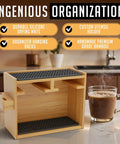Bamboo AeroPress coffee organizer stand on countertop with silicone mats, custom utensil holder and mug beside it.