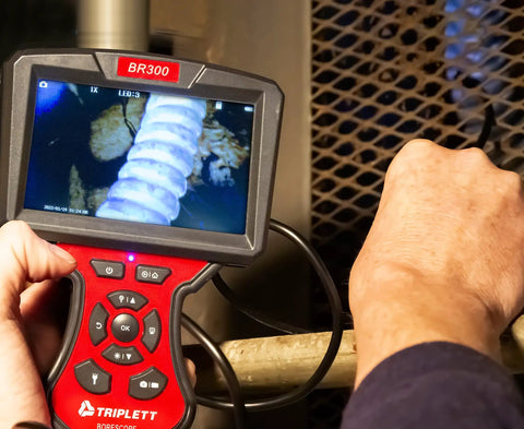 Person using Forward View Pro Grade Waterproof 5.5mm Videoscope With 5 Inch 1920x1080 Color LCD Display in inspection.