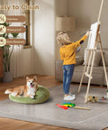 Child painting on easel in living room with dog on floor, showcasing waterproof and stain-resistant features of modern rug.