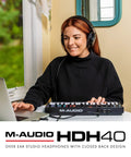 Person using Dope Over Ear Studio Headphones With Closed Back Design, 40mm Neodymium Drivers, on laptop and audio controller