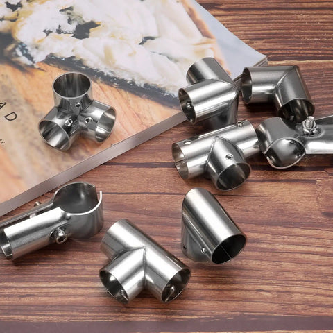 Six Piece 1 Inch Tee Pipe Connectors Set for DIY Shelves and Garden Supports, stainless steel, on wooden surface, silvery finish.