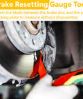 Image showing the 8 Piece Brake Pad Thickness Gauges Set with Color Coded Scale measuring brake pad thickness on a vehicle.