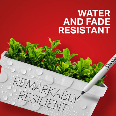 Close-up of Premium Ultra Fine Permanent Markers In Black used on a white plant pot, showcasing water and fade resistance.