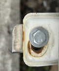Hex head bolt 3/8-16 through white metal bracket; stainless steel, plain finish.