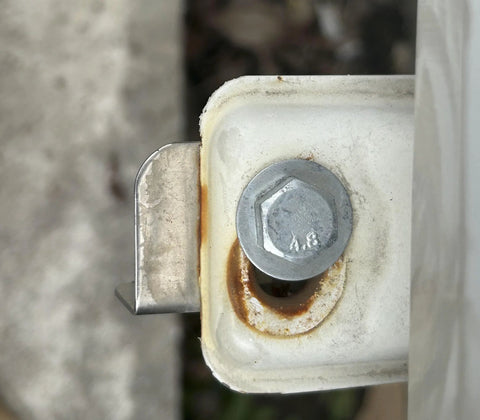 Hex head bolt 3/8-16 through white metal bracket; stainless steel, plain finish.