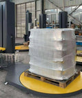 Industrial Strength Automatic Pallet Wrapping Machine Featuring Heavy Duty Turntable, wrapping palletized load with stretch film.