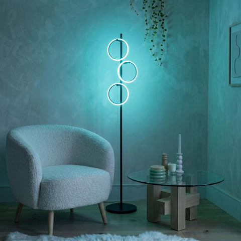 RGB Color Changing Floor Lamp With Tall Tree Design, Matte Black Finish, in a living room corner, smooth RGB gradient glow.
