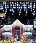132Ft Outdoor Christmas Lights With 1222 LEDs And 282 Drops illuminating a house at night with blue mood glow, moon in background, adapter shown