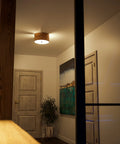 Shaker 3 Light Flush Mount Fixture In Brown Finish With Blackened Bronze Frame And Woven Wood Detailing in modern hallway