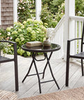 Compact Outdoor Folding Side Table With Tempered Glass Top And Heavy Duty Steel Frame for patio with books and vase.