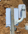 Universal Wireless Bridge Bracket Mount 2 Pack Pole And Wall Mount For Outdoor Antenna installed on a metal pole with cables.