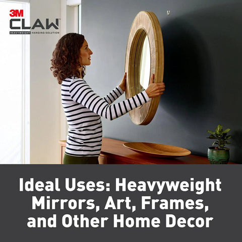 Person hanging mirror using Claw 65 Lb Drywall Picture Hangers With Spot Markers No Studs Needed 3 Pack Heavy Duty Hangers.
